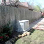 A white generator in a garden