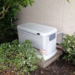 A white generator in a garden