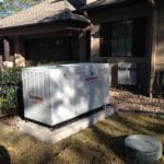 A large white generator outside a person's home