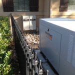A generac brand generator outside a home